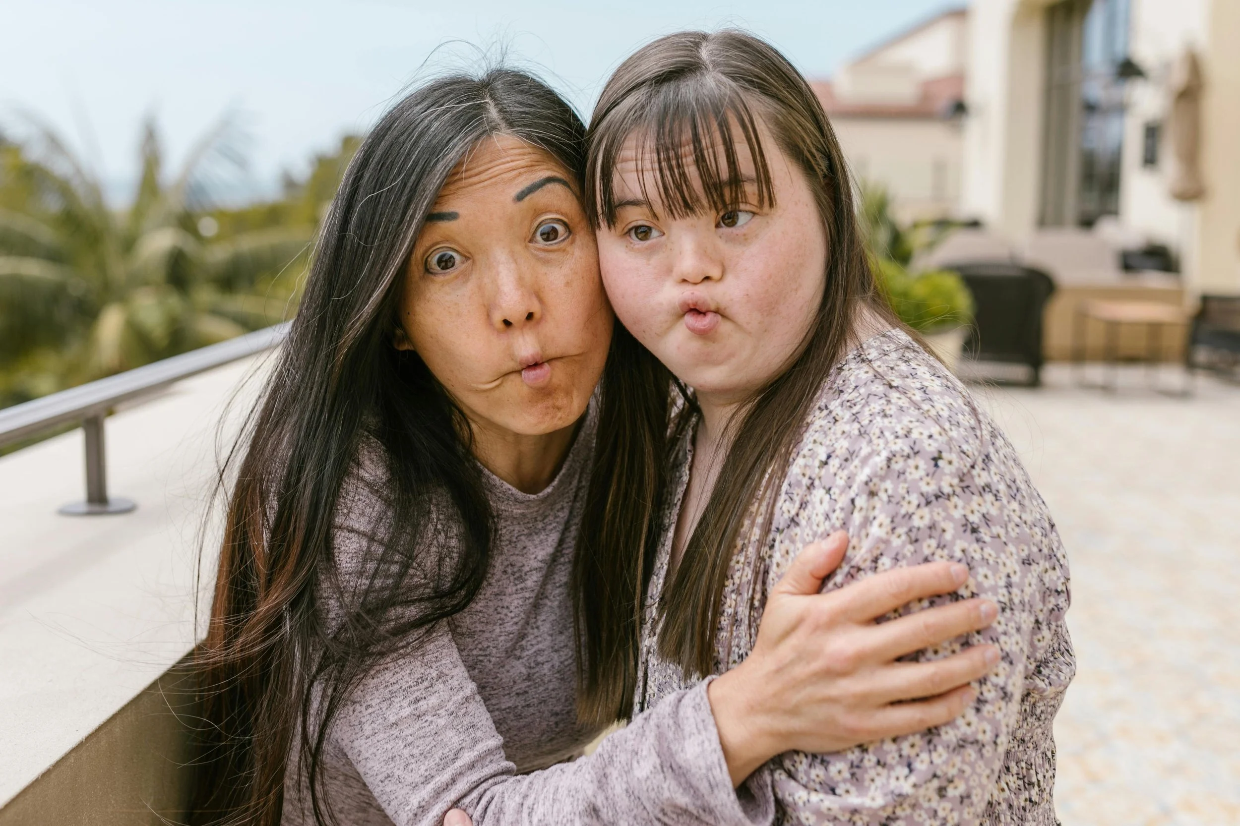 A woman and a girl sharing a playful moment.